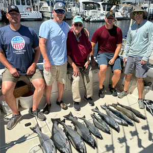 Group of 5 clients posing on the charter boat with the lake fish they caught